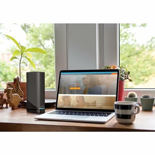 Home office desk with laptop and smart speaker